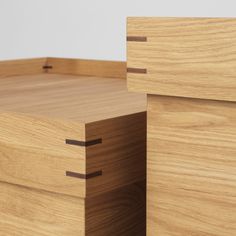 two pieces of wood stacked on top of each other with one drawer open and the other closed