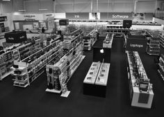 an apple store filled with lots of shelves and computers in it's center aisle