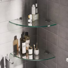 two glass shelves in the corner of a bathroom