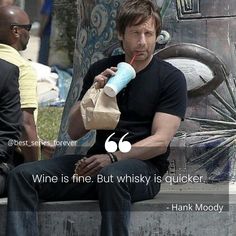 a man sitting on a bench with a drink in his hand and a quote about wine is fine, but whisky is quicker