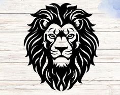 a black and white lion head on a wooden background