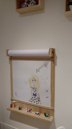 a child's drawing is hanging on the wall