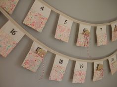 a number line made out of fabric hanging on the wall with numbers and ribbons attached to it