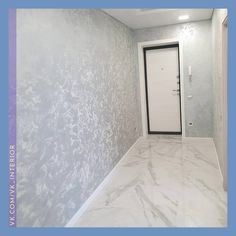 an empty room with a white door and wallpaper on the walls is pictured in this image