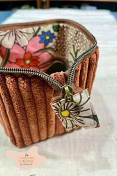 a small purse with a flowered design on it