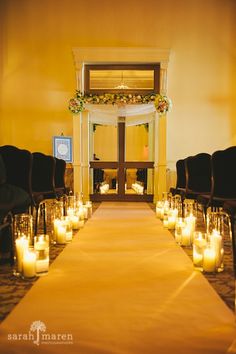 the aisle is lined with candles and chairs