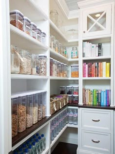 an organized pantry with lots of books, cereals and other items on shelves in the corner