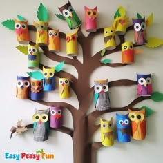 an owl family tree made out of toilet paper rolls and other colorful owls sitting on the branches