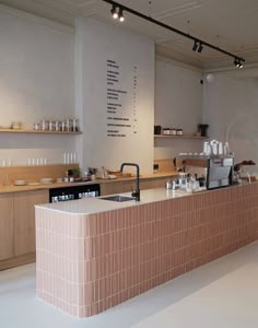 the counter in this restaurant is made of bricks and has many dishes on top of it