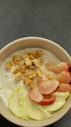 a bowl filled with yogurt, apples and granola