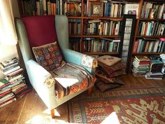 a chair in front of a bookshelf full of books