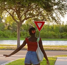 a woman holding a stop sign in her hand