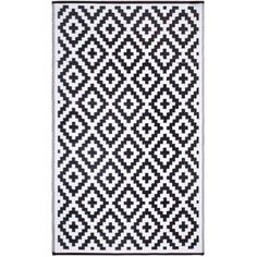 a black and white rug with an abstract design on the bottom, in front of a white background