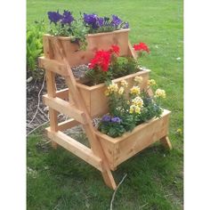 three wooden planters with flowers growing in them