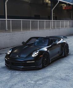 a black sports car parked in front of a building