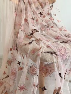 a white and pink floral print sheer curtain