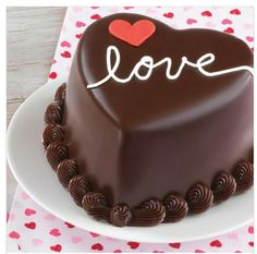 a heart shaped chocolate cake with the word love written on it