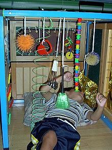 a young boy laying on the floor with toys