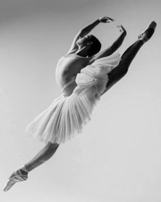 a black and white photo of a ballerina