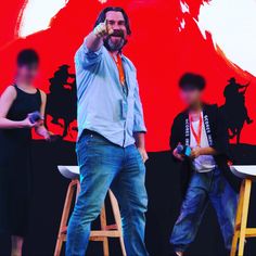 a man standing on top of a wooden stool