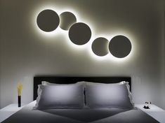 a bed with four round lights above it