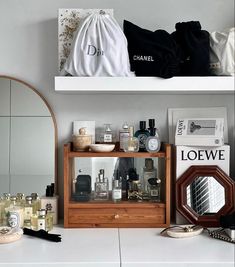 a bathroom counter with personal care items on it and a mirror in the corner next to it