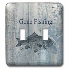 a light switch cover with a fish on it's side and the words gone fishing written