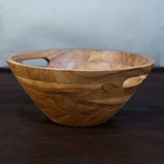 a wooden bowl sitting on top of a table