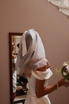 the bride is getting ready to walk down the aisle in her wedding dress and veil