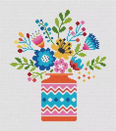 a cross stitch pattern with flowers in a vase