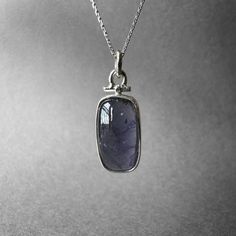 Stunning Large Size Violet Blue Iolite Necklace - Blue Iolite Pendant - Viking Compass Stone - Completely Handmade & Sterling Silver Gemstone: Natural Blue Iolite Metal: 925 Sterling Silver Stone Cuts: Cabochon Stone Size: 19.2 x 11.3 mm - 0.75 in x 0.44 in Pendant Size: 32.7 mm x 12.2 mm - 1.28 in x 0.48 in Weight: 5.96 grams (29.80 carats) total weight of stone and silver.  For ring orders, ring resizing is free.  Chains are gifts for necklace orders. Note: We don't use any filters for photos. The details may not be clear. Feel free to contact us with any questions, special orders or additional photo or video requests. We will be happy to provide more information! :) WORLDWIDE FedEx, UPS or TNT EXPRESS MAIL SERVICE (Delivery time: 1 - 5 business days.) LAYAWAY PAYMENT PLAN is available. Sapphire Gemstone Jewelry With Rectangular Pendant, Sapphire Kyanite Gemstone Necklace, Blue Amethyst Pendant Jewelry, Faceted Blue Amethyst Jewelry, Blue Faceted Amethyst Jewelry, Tanzanite Birthstone Pendant Jewelry, Tanzanite Birthstone Pendant, Blue Amethyst Birthstone Jewelry, Silver Faceted Tanzanite Jewelry