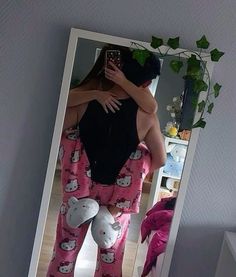 a man in hello kitty pajamas hugging his girlfriend