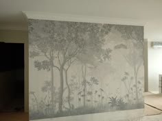 a room with a large mural on the wall next to a bed and dresser in it