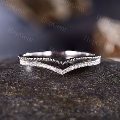 a close up view of a wedding ring with diamonds on the top and bottom part