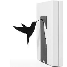 a black and white photo of a hummingbird on the side of a refrigerator door