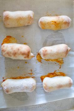 several sausages are on a baking sheet ready to go into the oven