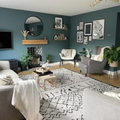 a living room filled with furniture and a flat screen tv mounted on the wall above a fireplace