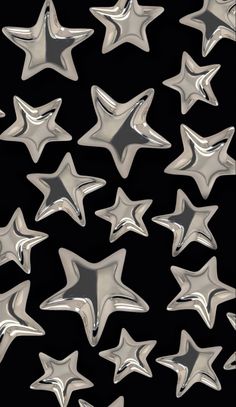 many shiny silver stars on a black background