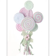 a bouquet of candy lollipops on top of each other in pastel colors