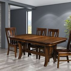 a dining room table with chairs and a potted plant in the corner next to it