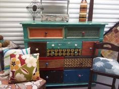 an old dresser with many different colored drawers