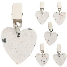 six white heart shaped tags with clips attached to them