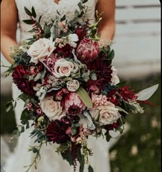 a bride holding a bouquet of flowers in her hands