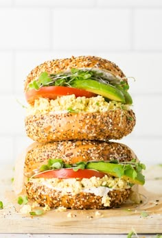 the ultimate vegan breakfast sandwich with tofu scramble on whole wheat buns and topped with fresh veggies