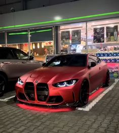 two cars parked next to each other in front of a store