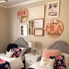 two twin beds in a room with pictures on the wall above them and pillows below