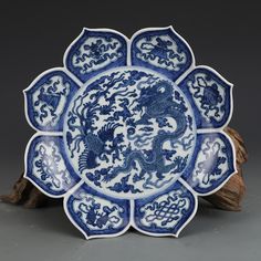 a blue and white plate with dragon designs on it