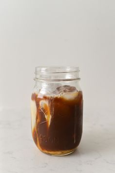 a jar filled with liquid sitting on top of a table