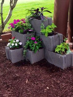 several cement planters are stacked on top of each other in front of a tree