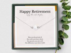 a gift box with a necklace that says happy retirement